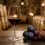 Gelas kristal berisi wine Merlot merah delima dengan buah plum dan latar belakang tong kayu oak